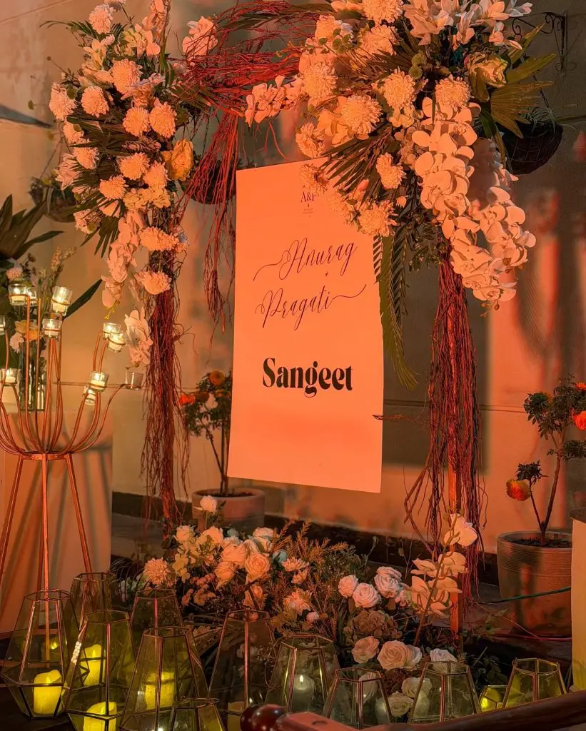 Floral arch and candlelit welcome sign for Pragati and Anurag’s sangeet