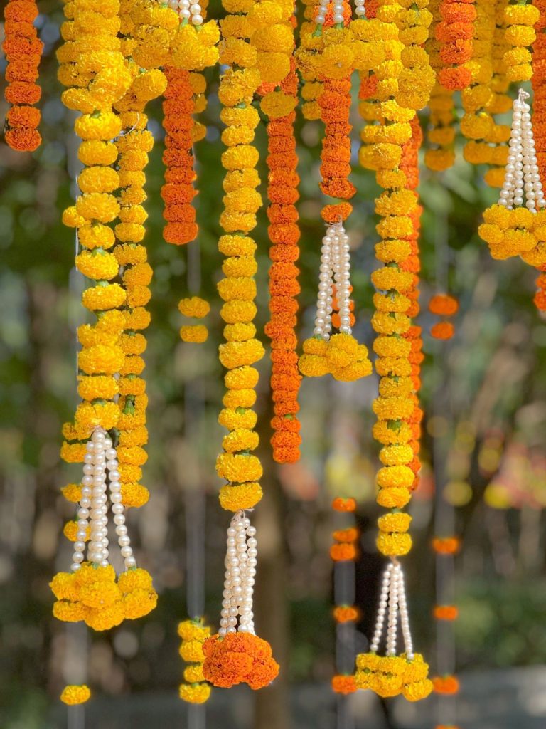 Marigold strings finished with white bead tassels.