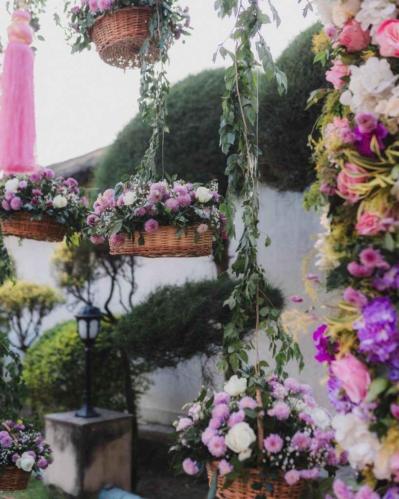 Hanging wicker baskets with pink, lilac and white flowers at the tilak