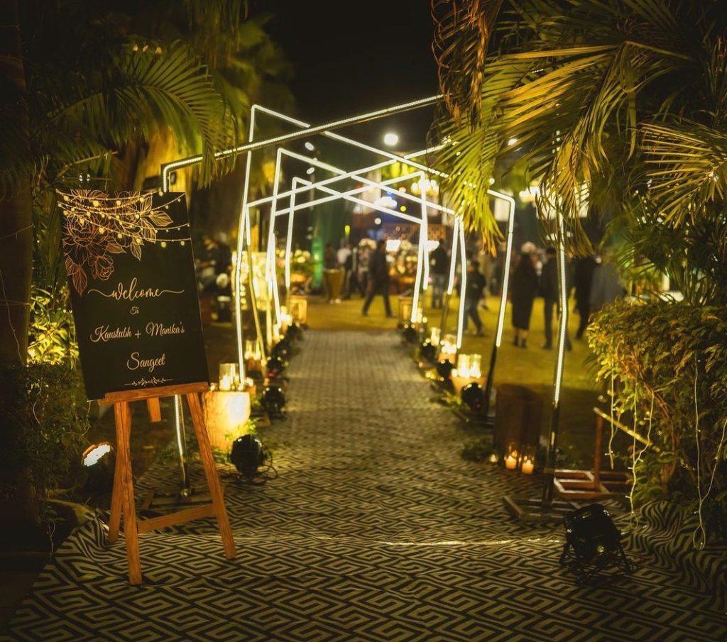 Illuminated geometric walkway and welcome sign at Manika and Kaustubh’s sangeet