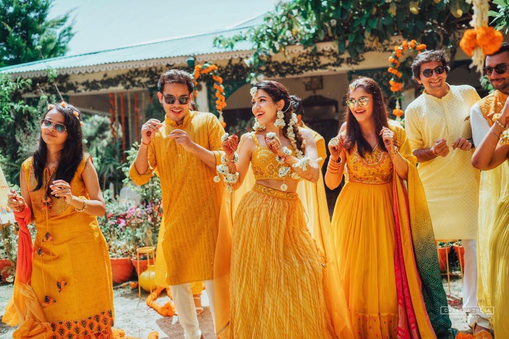Niharika and Anirudh dancing with family in yellow outfits at their haldi